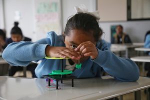 Niña de escuela de la CDMX en un taller del programa de robótica móvil de la AMC